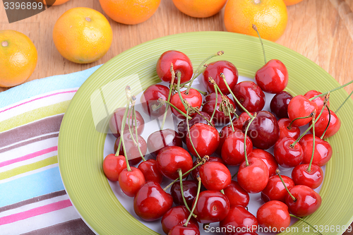 Image of mandarin and cherry fresh fruits and berries, summer health food