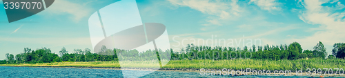 Image of Beach landscape with blue water and green trees