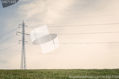 Image of Tall pylons on a green field