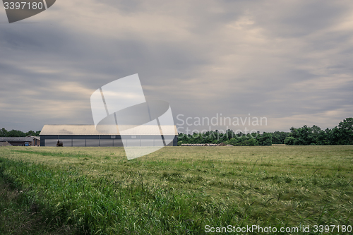 Image of Barn on a field in cloudy weather