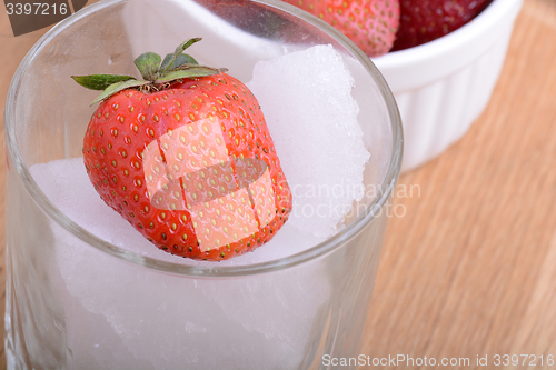 Image of strawberry frozen in ice cube, health food concept