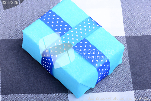 Image of blue gift box with white ribbon