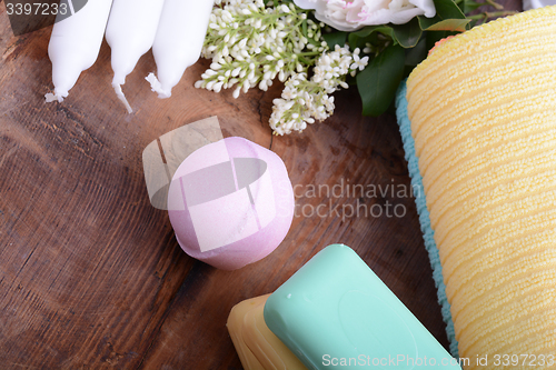 Image of towels set, aroma therapy, soap and sea salt on wooden plate 