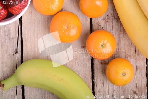 Image of Fresh colorful fruits composition mandarin, bananas and orange
