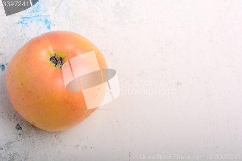 Image of apple on old white plate