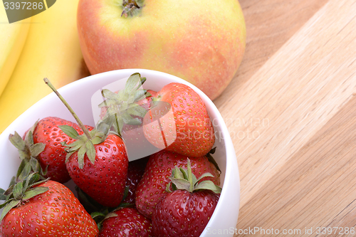 Image of Close-up shot of variety of fruits on old wooden plate