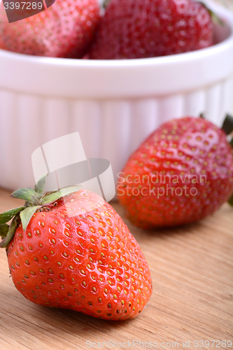 Image of close up of big strawberry on wood