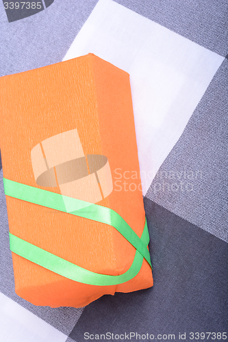 Image of orange gift box with green ribbon