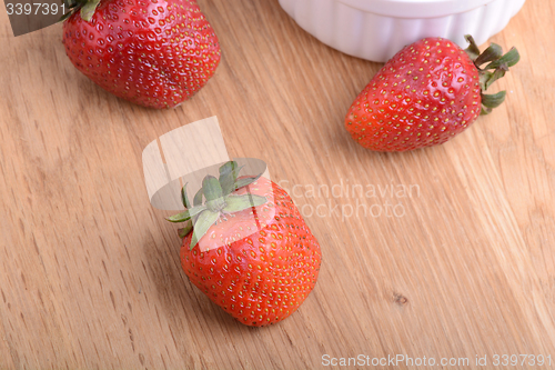 Image of close up of big strawberry on wood