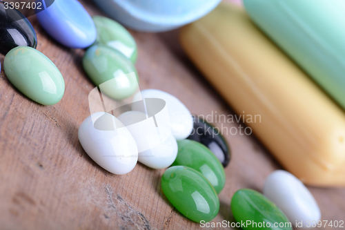 Image of Beautiful spa setting with stone set, soap and sea salt on wooden table close up