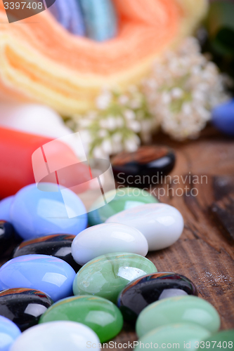 Image of Spa still life with aromatic candles, stones, flower and towel, close up