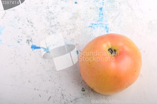 Image of apple on old white plate