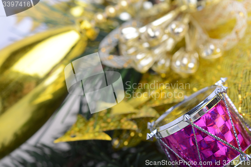 Image of Christmas wreath with golden ornaments - new year drum, glass ball, Christmas present