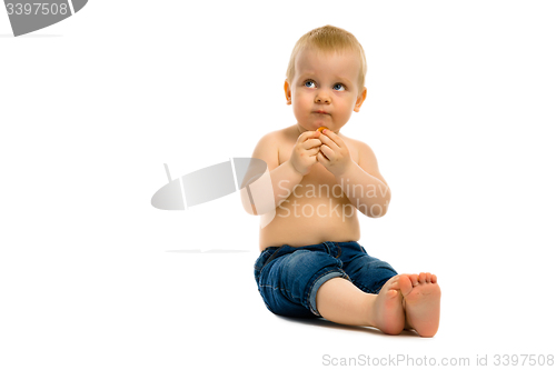 Image of baby sitting on a white floor