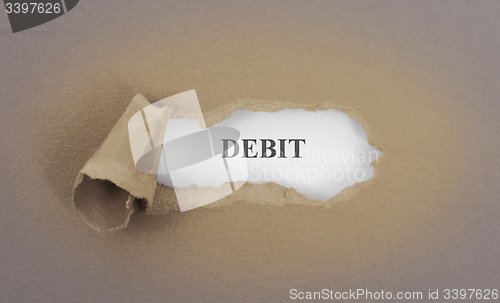 Image of Text appearing behind torn brown envelop