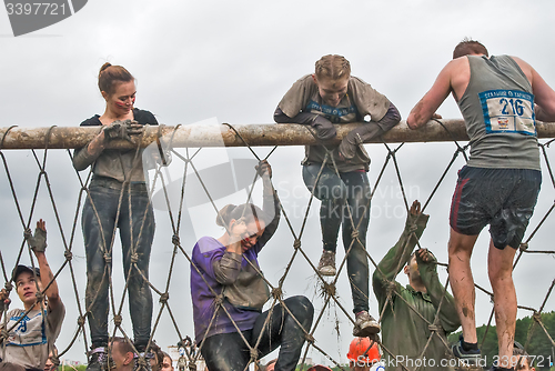 Image of Team storms net wall in extrim race. Tyumen.Russia