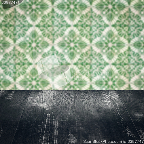 Image of Wood table top and blur vintage ceramic tile pattern wall