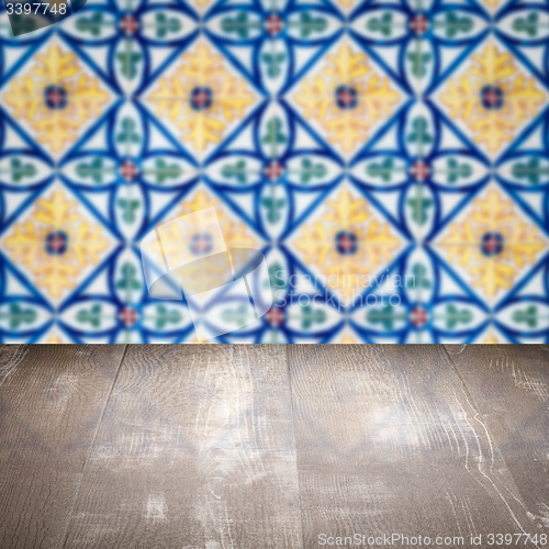Image of Wood table top and blur vintage ceramic tile pattern wall