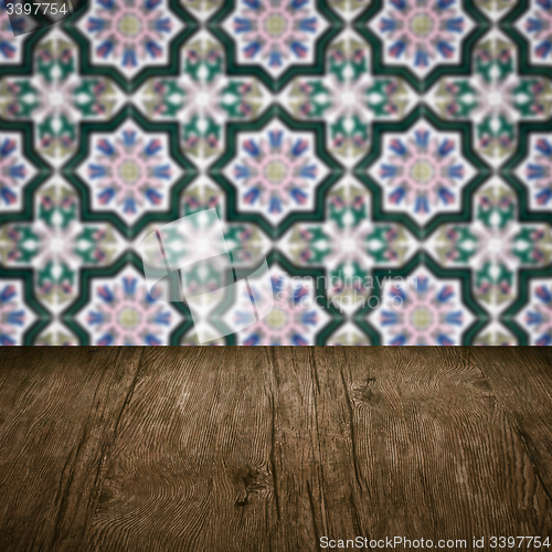Image of Wood table top and blur vintage ceramic tile pattern wall