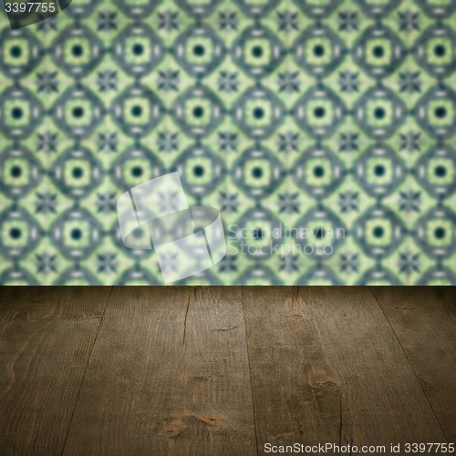 Image of Wood table top and blur vintage ceramic tile pattern wall