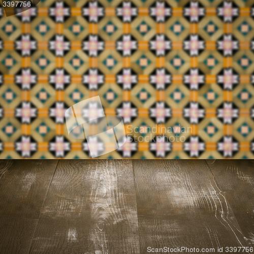 Image of Wood table top and blur vintage ceramic tile pattern wall