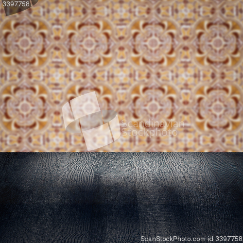 Image of Wood table top and blur vintage ceramic tile pattern wall