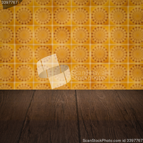 Image of Wood table top and blur vintage ceramic tile pattern wall