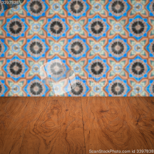 Image of Wood table top and blur vintage ceramic tile pattern wall