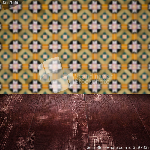 Image of Wood table top and blur vintage ceramic tile pattern wall