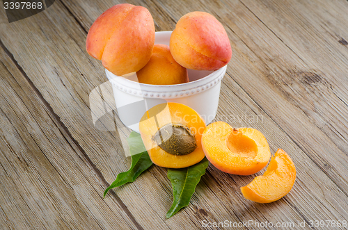 Image of Apricots on wooden table.