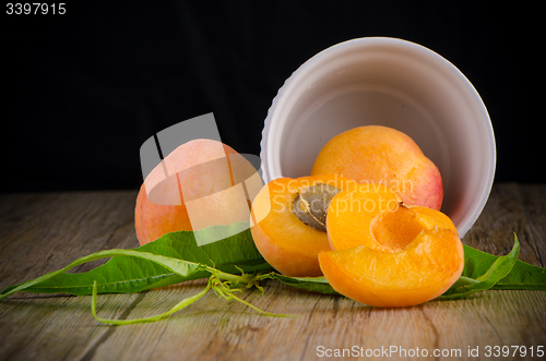 Image of Apricots on wooden table.