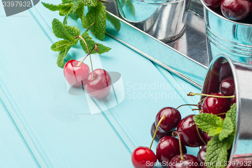 Image of Cherries in blue wooden table