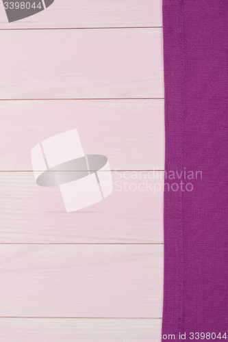 Image of Purple towel over wooden table