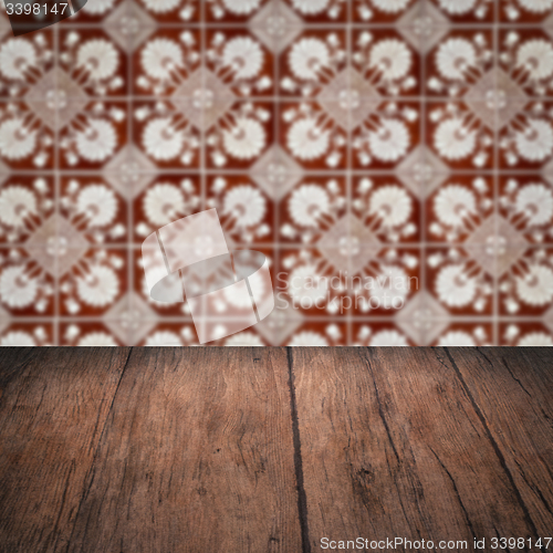 Image of Wood table top and blur vintage ceramic tile pattern wall