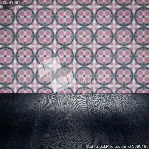 Image of Wood table top and blur vintage ceramic tile pattern wall