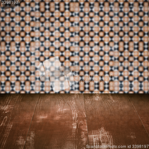 Image of Wood table top and blur vintage ceramic tile pattern wall