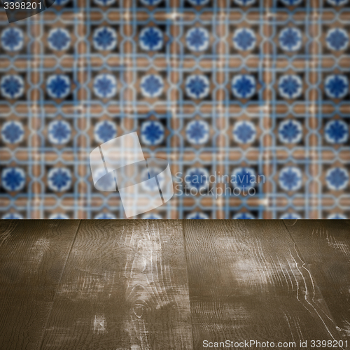 Image of Wood table top and blur vintage ceramic tile pattern wall