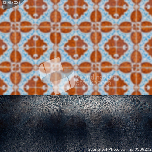 Image of Wood table top and blur vintage ceramic tile pattern wall