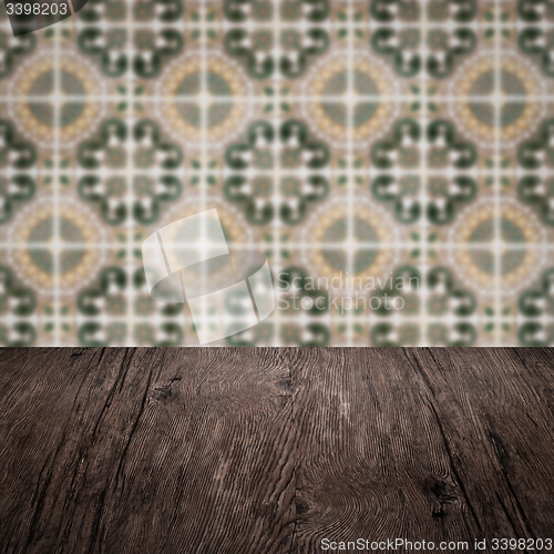 Image of Wood table top and blur vintage ceramic tile pattern wall