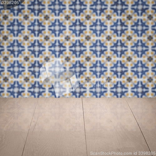 Image of Wood table top and blur vintage ceramic tile pattern wall