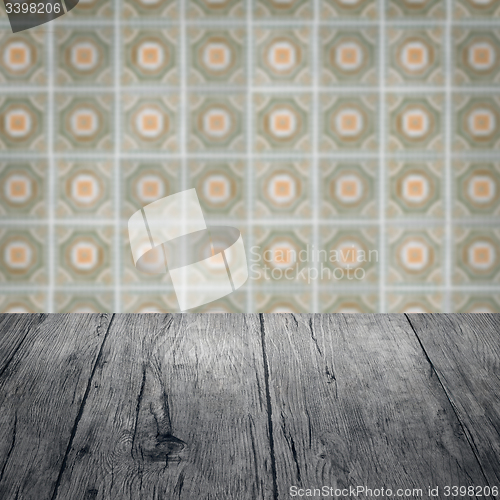 Image of Wood table top and blur vintage ceramic tile pattern wall