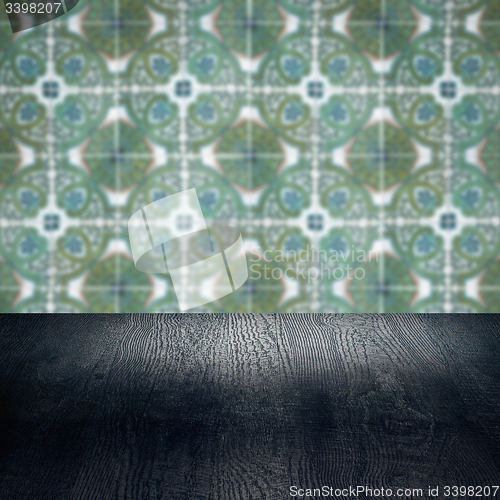 Image of Wood table top and blur vintage ceramic tile pattern wall