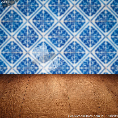 Image of Wood table top and blur vintage ceramic tile pattern wall