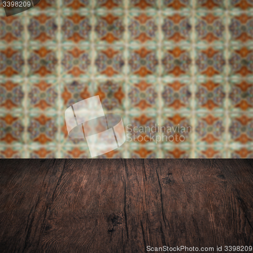 Image of Wood table top and blur vintage ceramic tile pattern wall