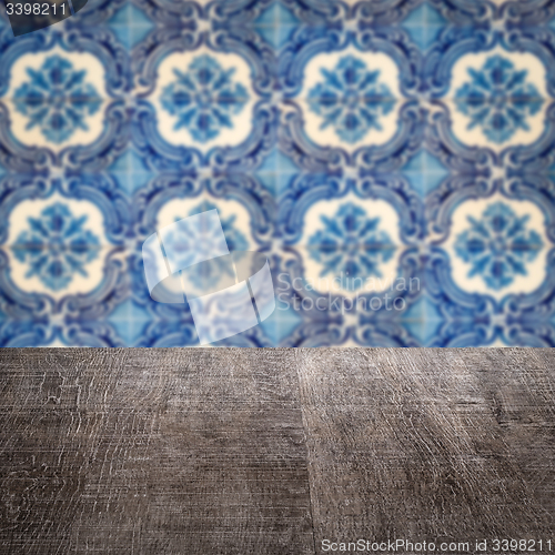 Image of Wood table top and blur vintage ceramic tile pattern wall