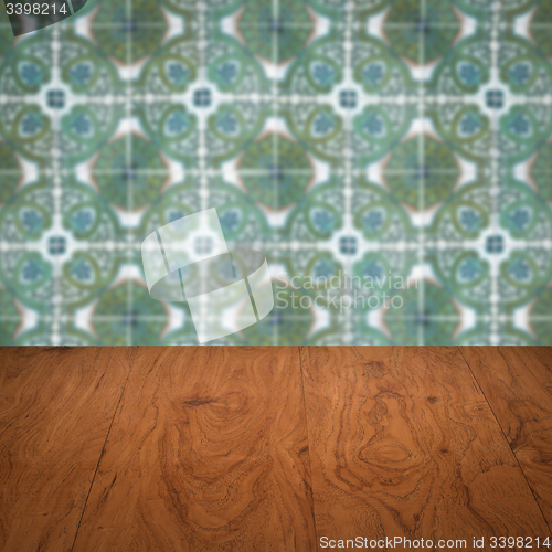 Image of Wood table top and blur vintage ceramic tile pattern wall