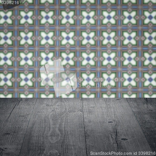 Image of Wood table top and blur vintage ceramic tile pattern wall