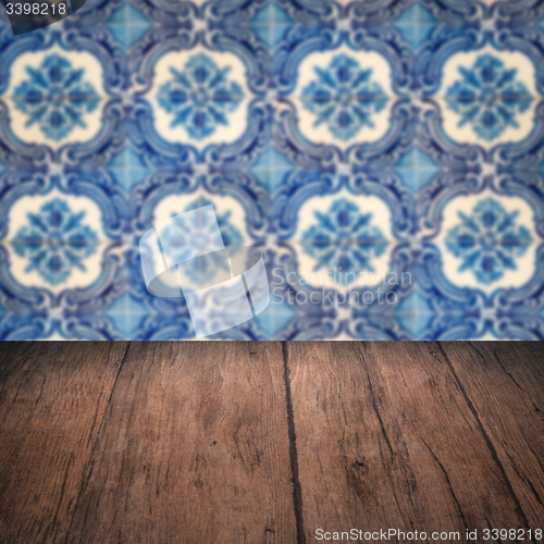 Image of Wood table top and blur vintage ceramic tile pattern wall