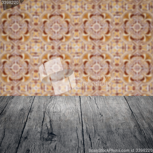Image of Wood table top and blur vintage ceramic tile pattern wall