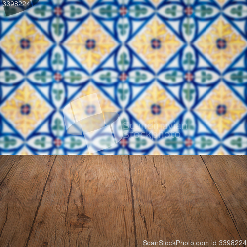 Image of Wood table top and blur vintage ceramic tile pattern wall